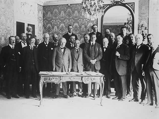 Churchill is standing in the front row, third to the right of David Lloyd George. Sir Henry Wilson is immediately behind and to the right of Churchill.